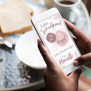 May include: A smartphone displaying a save the date announcement for a school-aged child's birthday party. The announcement is pink and white with the text "Endlich Schulkind" and "Save the Date" with a date of August 31, 2023. The announcement also includes the text "Weitere Informationen folgen" and "Eure  Marielle".