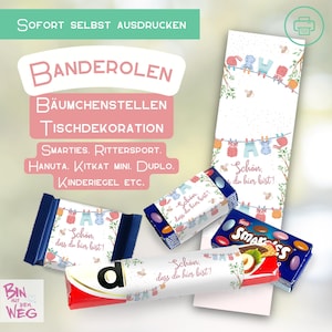 Puede incluir: Una variedad de barras de chocolate y envoltorios de papel decorativos con el texto "Schön, dass du hier bist!" y un diseño de ropa colgada. La imagen también incluye el texto "SOFORT SELBST AUSDRUCKEN" y "BANDEROLEN".