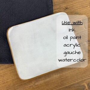 May include: A white rectangular artist's palette with rounded corners and a light brown edge. The text on the image reads "Use with Ink, oil paint, acrylic, gouache, watercolor."