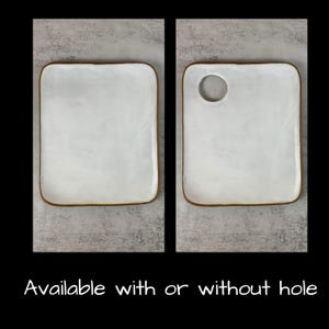 May include: Two white ceramic serving platters, one with a circular hole. Both have a rectangular shape with rounded corners and a brown rim. The text "Available with or without hole" is at the bottom.
