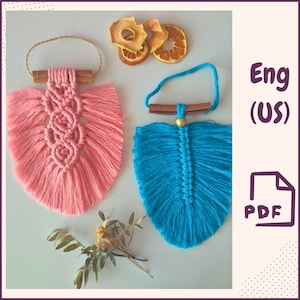 May include: Two macrame feather wall hangings, one pink and one blue, with cinnamon sticks and a gold bead accent. Eng (US) PDF.