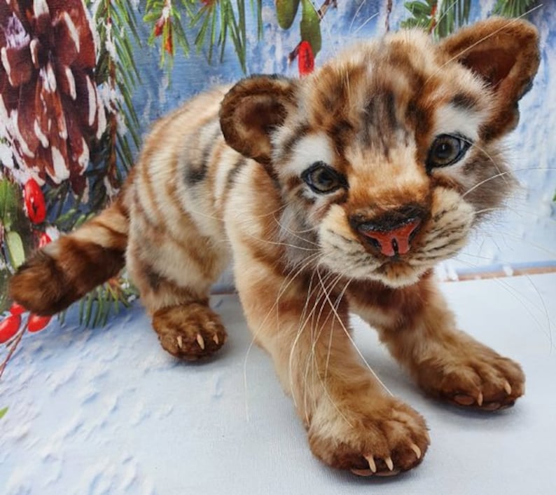 On floor: Poseable tiger plush doll lying on its belly – stuffed animal sewing project

Looking up: Tiger cub collectible toy – made from A4 printable PDF sewing pattern