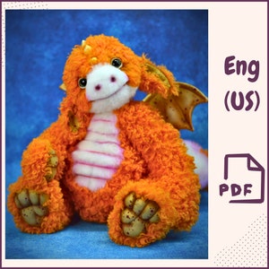 May include: A plush orange and pink dragon teddy bear with gold accents. The dragon has a pink belly and a white stripe down its back. The dragon is sitting on a blue background.