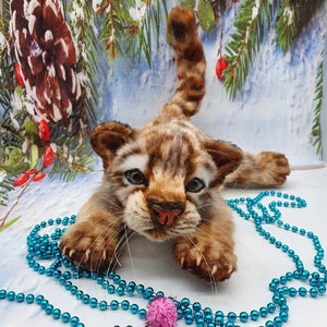 With beads: Handmade tiger cub plush next to beaded decor – sewing pattern example