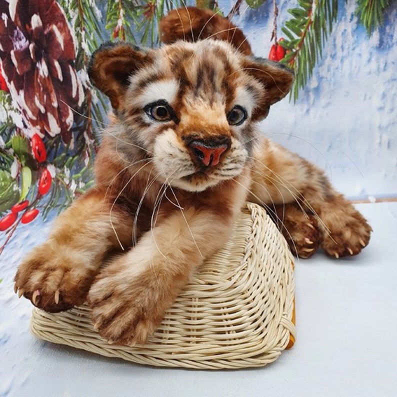 Toy in basket: Finished poseable tiger toy sitting in a basket – sewn from printable pattern