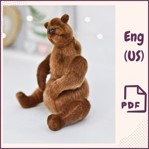 May include: A handmade brown teddy bear with a detailed fur texture. The bear is sitting with its legs extended and arms raised. The image includes the text "Eng (US)" and a PDF icon.