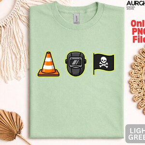 May include: Light green t-shirt with a graphic featuring a traffic cone, a welding mask, and a pirate flag with a skull and crossbones. The shirt also has the text "Only PNG File" and "LIGHT GREEN".