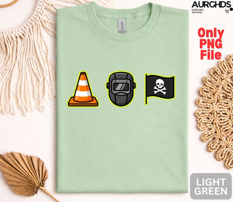 May include: Light green t-shirt with a graphic featuring a traffic cone, a welding mask, and a pirate flag with a skull and crossbones. The shirt also has the text "Only PNG File" and "LIGHT GREEN".