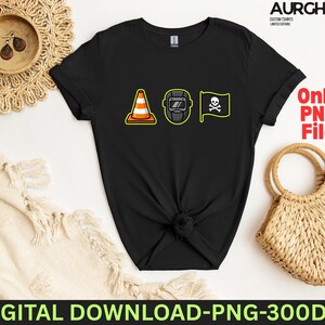 May include: Black t-shirt featuring three cartoon graphics: a traffic cone, a welding mask, and a pirate flag with a skull and crossbones. The shirt has the text "Only PNG File".