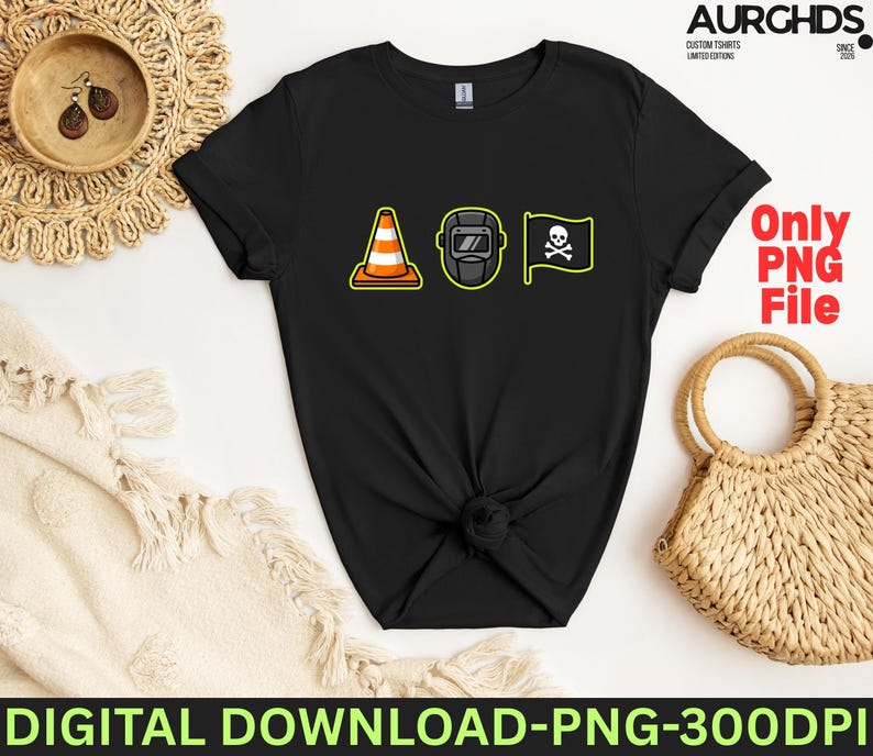 May include: Black t-shirt featuring three cartoon graphics: a traffic cone, a welding mask, and a pirate flag with a skull and crossbones. The shirt has the text "Only PNG File".