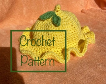 May include: A yellow crochet lemon hat with green leaves. Crochet pattern.