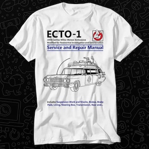 May include: A white t-shirt with a black and white illustration of the Ghostbusters' Ecto-1 car. The text "ECTO-1" is printed in black at the top of the shirt. The text "1959 Cadillac Miller-Meteor Ambulance" is printed in black below the car. The text "Modified for Paranormal Investigation and Extermination" is printed in black below the car. The text "Service and Repair Manual" is printed in black below the car. The text "Includes Suspension Work and Shocks, Brakes, Brake Pads, Lining, Steering Box, Transmission, Rear-end..." is printed in black at the bottom of the shirt.