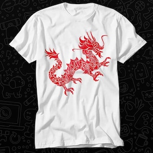 May include: White t-shirt featuring a red dragon design. The dragon is stylised and detailed with intricate patterns.