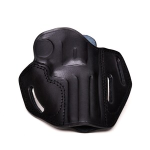 May include: Black leather holster with stitching detail. The holster has a flap and a belt loop.
