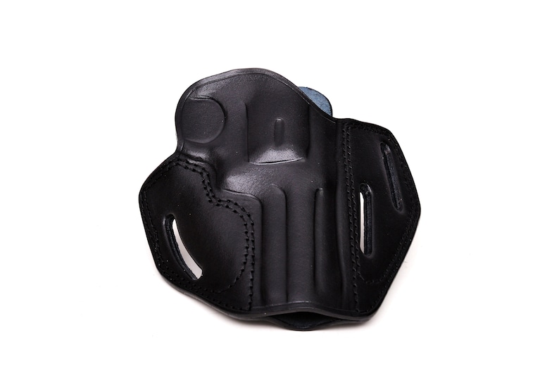 May include: Black leather holster with stitching detail. The holster has a flap and a belt loop.