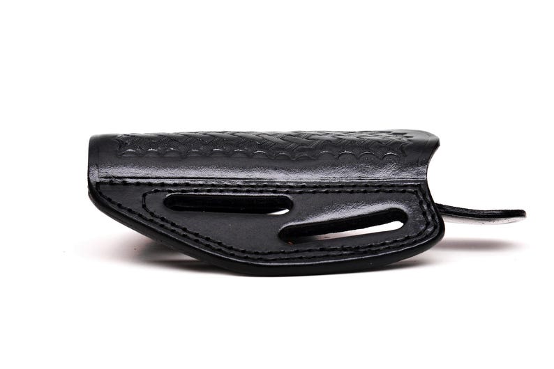 Op de afbeelding: Een zwart leren holster met een gestructureerd ontwerp en uitsparingen voor een pistool.