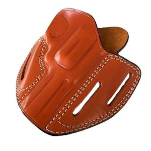 May include: A brown leather holster with white stitching. The holster has a belt loop and a slot for a magazine.