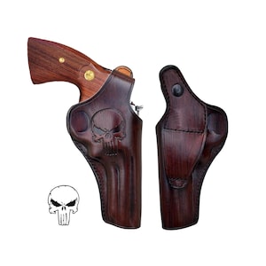 May include: A brown leather holster with a skull design. The holster is designed to fit a revolver.