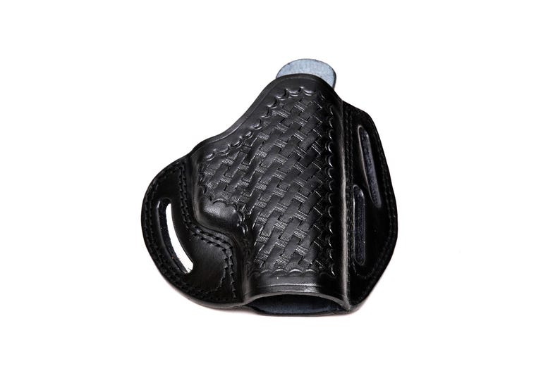 Op de afbeelding: Een zwart leren holster met een geweven patroon. Het holster heeft een riemlus en een trekkerbescherming.