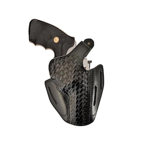 May include: A black leather holster with a woven pattern for a revolver. The holster has a belt loop and a trigger guard.
