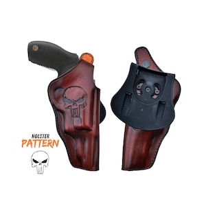 May include: A brown leather holster with a skull design. The holster is designed for a handgun and has a black plastic belt clip.
