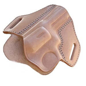 May include: A light brown leather holster with a molded design to fit a revolver. The holster has black stitching around the edges and features belt loops. The interior is a lighter shade of brown.