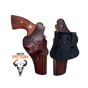 May include: A brown leather holster with a wood grain pattern and a skull design. The holster is designed for a revolver and has a belt loop on the back.