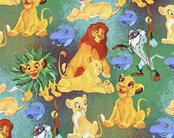 May include: A green fabric with a repeating pattern of cartoon lions from the movie The Lion King. The lions are in various poses, including sitting, standing, and lying down. There are also some green plants and blue clouds in the pattern.