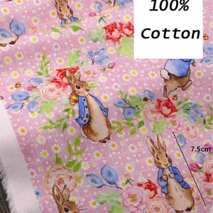 May include: Pink cotton fabric with a repeating pattern of bunnies wearing blue jackets, flowers, and a white and pink checkered pattern. The fabric is labeled "No. 109" and "100% Cotton".