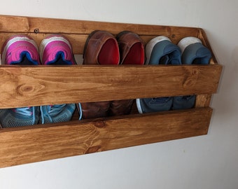 Wall mounted shoe rack . Hall way . various,sizes , different coloured waxes