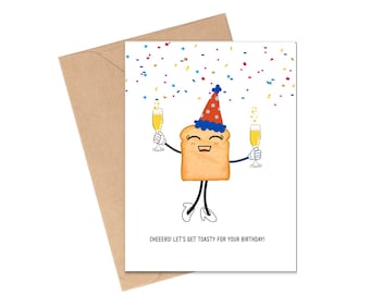 May include: A birthday greeting card featuring a cartoon slice of toast wearing a party hat and holding two champagne flutes. The card has the text "Cheeers! Let's get toasty for your birthday!" and is paired with a brown envelope.