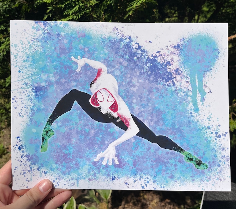 Pode incluir: Uma impress&atilde;o art&iacute;stica com uma ilustra&ccedil;&atilde;o estilizada de uma super-hero&iacute;na em pose din&acirc;mica. A personagem usa um fato branco e vermelho com leggings pretas, num fundo de salpicos de tinta azuis e roxos. Estilo banda desenhada.
