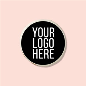 May include: A white round cookie with black icing and the text "YOUR LOGO HERE" in white.