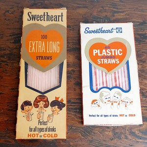 May include: Two boxes of Sweetheart brand drinking straws. The box on the left has 100 extra long straws and the box on the right has 65 jumbo plastic straws. Both boxes feature a heart design with the brand name and straw count.