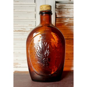 Vintage Commemorative Log Cabin Amber Glass Syrup Bottle 1776 Indian with original cap, made in 1976