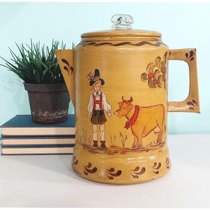 May include: A handmade wooden sign with the text "Welcome" in a playful font. The sign is painted white with a distressed finish, and features a decorative floral design in shades of pink and green. It measures approximately 12 inches wide.