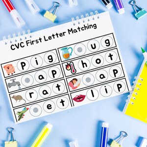 May include: A printable CVC first letter matching worksheet with images of a pig, a faucet, a rat, a plane, a hot iron, a sleeping person, a pair of lips, and letters. The worksheet is on a blue background with school supplies.