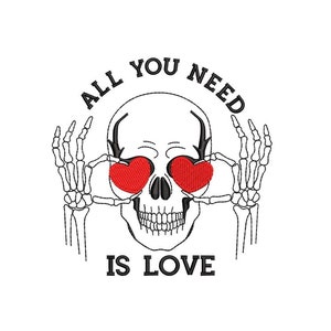 May include: A black and white illustration of a skull with red hearts for eyes. The skull is wearing a skeleton hand on each side of its head. The text "ALL YOU NEED IS LOVE" is written around the skull.