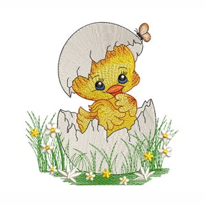 May include: A yellow chick with big blue eyes peeks out of a cracked white egg shell. The chick is surrounded by green grass and white flowers.