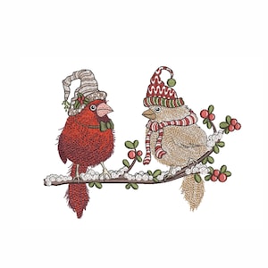 May include: Embroidered image of two birds perched on a snow-covered branch. One bird is red with a hat and bow tie, the other is tan with a hat and scarf. Berries and leaves are also on the branch.