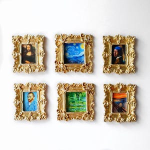 May include: Six small framed art prints featuring famous paintings like the Mona Lisa, Starry Night, and The Scream. The frames are ornate, gold-colored, and square, with detailed floral designs. The art prints are colorful and vibrant.