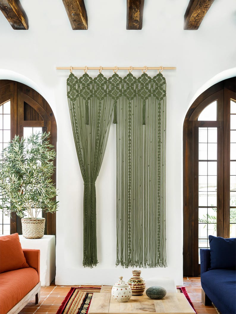 Floor-to-ceiling olive green macrame curtain used as a bohemian closet cover.