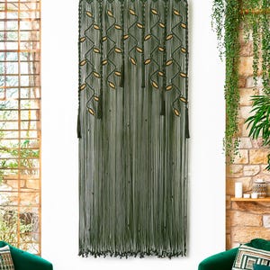 Extra-large dark green macrame wall hanging with a cascading leaf and vine pattern.
