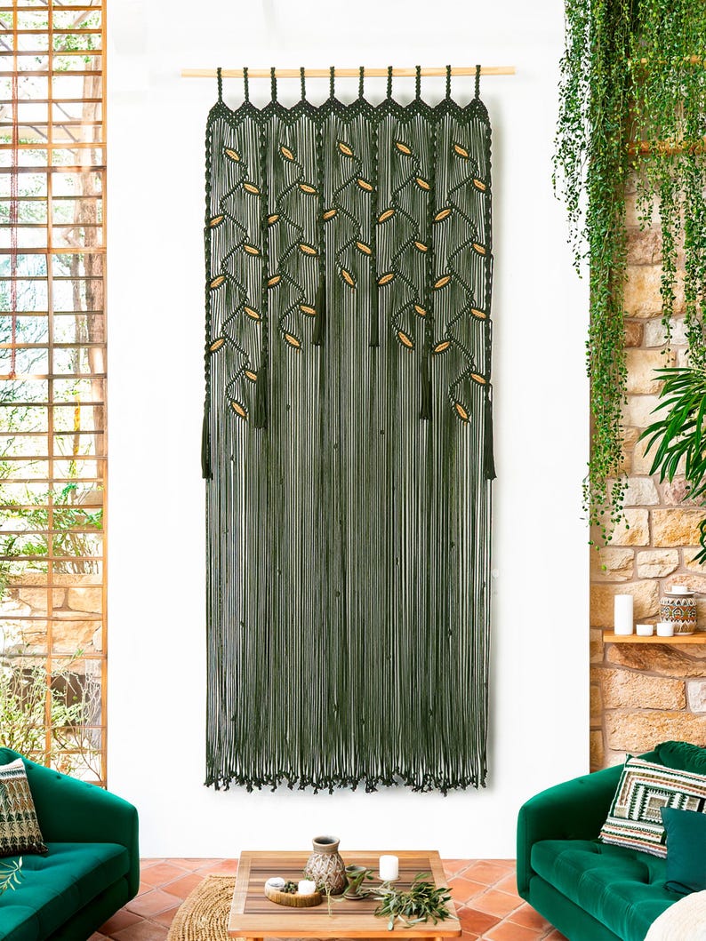 Extra-large dark green macrame wall hanging with a cascading leaf and vine pattern.