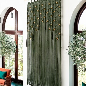 Large forest green doorway curtain with fringe tassels and latte-colored leaf weaving.