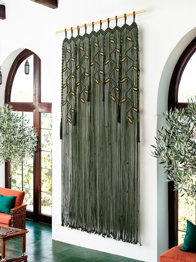 Large forest green doorway curtain with fringe tassels and latte-colored leaf weaving.