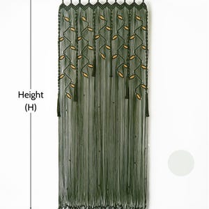 Handcrafted two-tone macrame curtain in earthy forest green and soft latte beige.