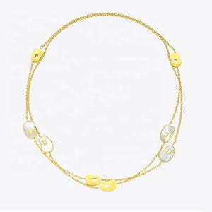 May include: A gold-colored necklace with a delicate chain design. The necklace features several rectangular and oval-shaped pendants with a white, pearlescent inlay. The necklace is designed to be worn around the neck.