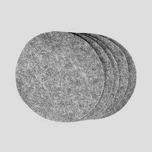 May include: A stack of six gray felt coasters. The coasters are round and have a textured surface. The coasters are made of a soft, durable material and are suitable for protecting surfaces from heat and moisture.