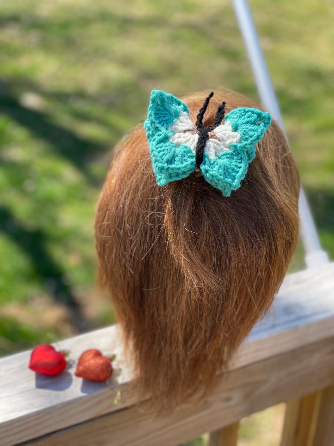 Photos of a little girl with 2 little sprout pony tails, blue eyes two butterfly hair clip used pink frok